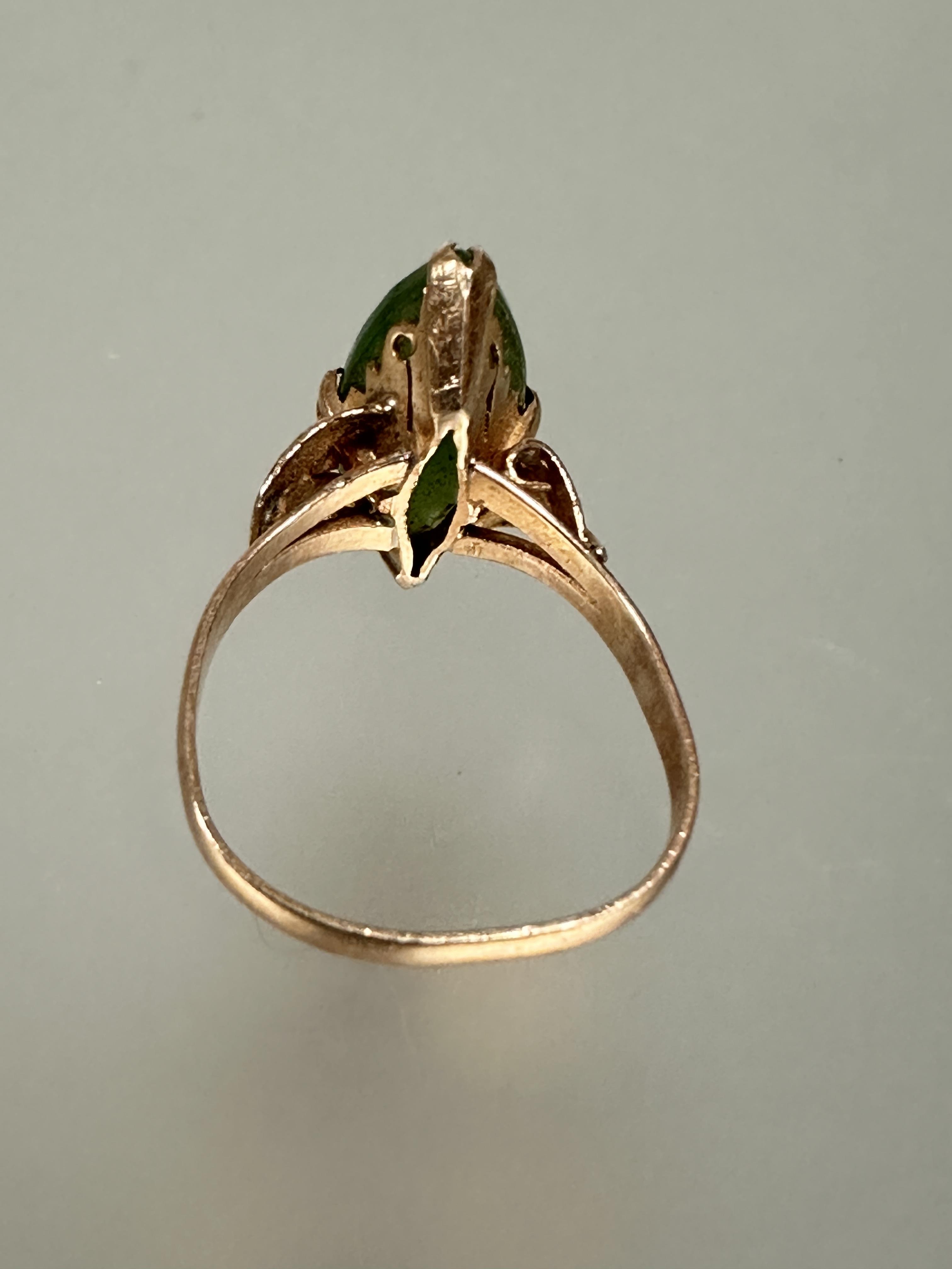 A 18ct gold ring set navette green stone mounted in four claw setting with scrolling leaf - Image 3 of 4