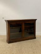 A Victorian rosewood bookcase, the projecting top above two glazed doors enclosing an interior