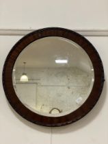 A 20th century mahogany framed circular wall mirror with bevelled glass. D62cm