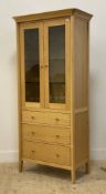 John Lewis, a contemporary light oak display cabinet / bookcase, fitted with two glazed doors