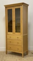 John Lewis, a contemporary light oak display cabinet / bookcase, fitted with two glazed doors