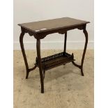 An Edwardian walnut occasional table, the rectangular lot on cabriole supports united by a galleried