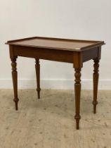 A Victorian mahogany console table, the top with 3/4 gallery, raised on turned and tapered supports.