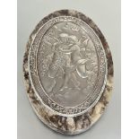 A gray alabaster oval panel mounted with continental plaque with chased fairy figures with