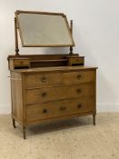 An Edwardian oak dressing chest, with geometric bevel glazed vanity mirror swivelling between two