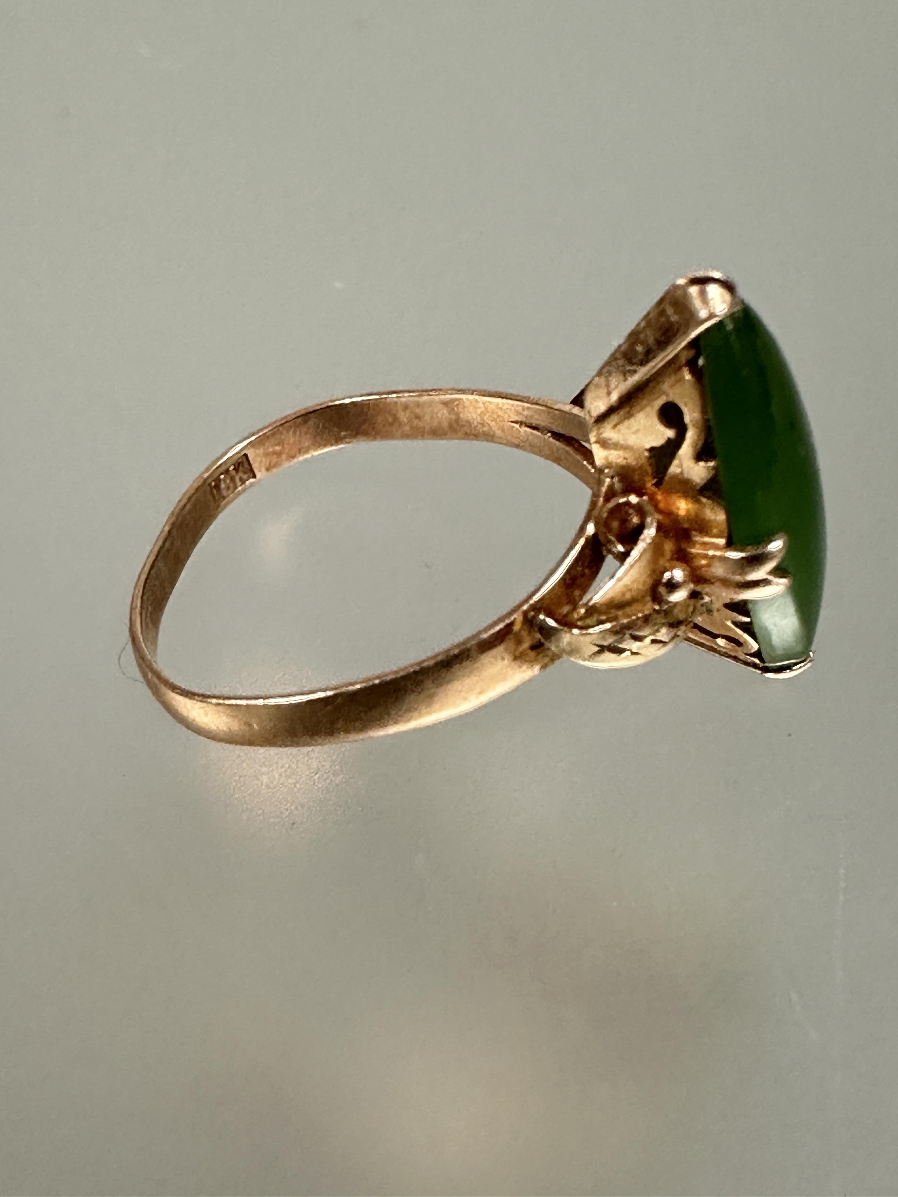 A 18ct gold ring set navette green stone mounted in four claw setting with scrolling leaf - Image 2 of 4