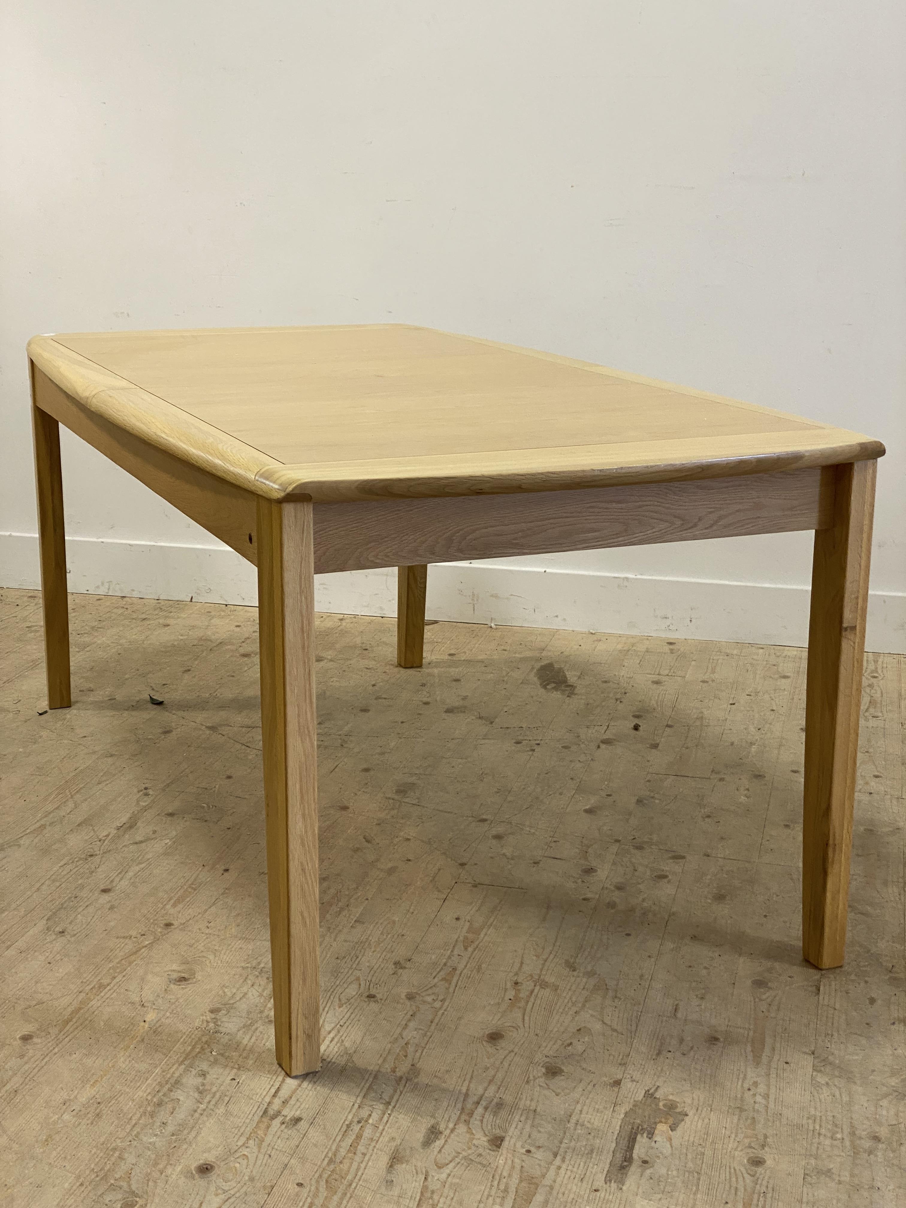 Ercol, a late 20th century / contemporary light oak extending dining table, with panelled top