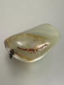 A carved celadon and russet jadite polished pebble mounted as pendant L x 4.5cm W x 4cm 58.8g