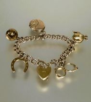 A 9ct gold hollow kerb link six charm bracelet with heart shaped padlock and safety chain (a/f),