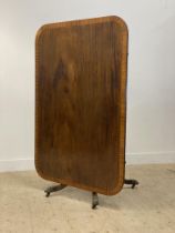 A Regency period mahogany breakfast table, the tilt top with deep satinwood cross band above four