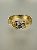 A 1960s 18ct gold solitaire round brilliant cut diamond ring in claw setting with hatched sides