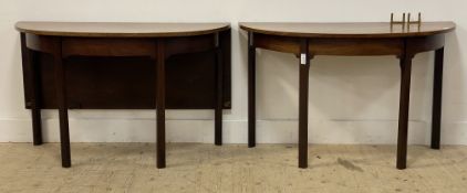 A George III mahogany 'D' end dining table, one end complete with drop leaf and brass forks, all