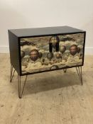 A Vintage painted two door cabinet with decoupage style decoration, raised on hairpin supports, with