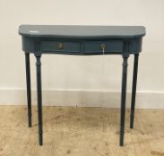 A traditional blue painted console table of serpentine outline, fitted with two drawers and raised