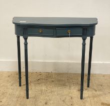 A traditional blue painted console table of serpentine outline, fitted with two drawers and raised