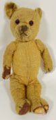 An early twentieth century vintage stuffed bear, plush covered with glass eyes (h- 36cm)