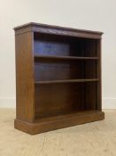 An oak open bookcase, fitted with two adjustable shelves, raised on a plinth base. H93cm, W91cm,