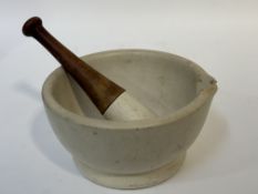 A Wedgewood stoneware pestle and mortar with a wooden handle. (shows signs of age and use) (chip