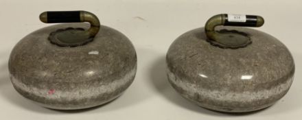 A pair of Scottish granite curling stones with ebony handles, and together with a matched spare