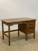 A 1930's oak typists desk, fitted with a slide and three drawers, raised on stile supports, makers
