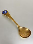 A Danish Georg Jensen silver gilt commemorative 1986 blue enamel anemone spoon by Annelise Bjorner L