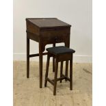 A 19th century walnut and mahogany clerks desk, the writing slant opening to a storage well, above a