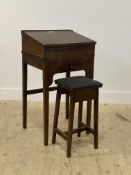 A 19th century walnut and mahogany clerks desk, the writing slant opening to a storage well, above a