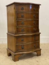 A Georgian style yew wood miniature chest on chest, the serpentine front fitted with six drawers,