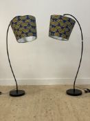 A pair of contemporary arc lamps, each complete with decorative shades.
