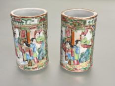 A pair of late 19thc Chinese Canton cylinder vases decorated in traditional style with figures in