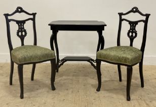 A late Victorian ebonised two tier side table, raised on cabriole supports. (H74cm, W72cm, D48cm)