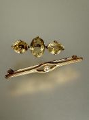 A yellow metal triple oval faceted cut citrine bar brooch L x 4cm and a gilt metal paste pearl