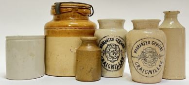 A collection of stoneware jars comprising two Craigmillar transfer printed jars, three smaller