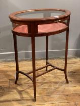 An Edwardian style mahogany bijouterie table, the oval top with chequered inlay and inset with