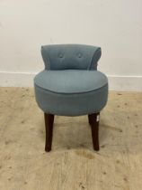 A dressing table stool, the seat and back upholstered in blue linen, raised on square tapered and