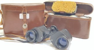 A pair of Barr and Stroud binoculars in leather case, together with a leather cased vanity set