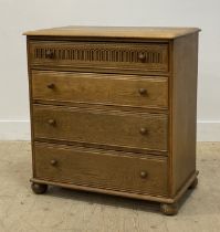 A 20th century oak chest of four long graduated drawers, raised on bun supports. H86cm, W81cm,