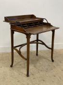 A campaign style walnut writing desk, the top folding over to reveal correspondence shelves and a