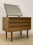 Avalon, A mid century teak dressing chest, with swing mirror above drawers to base, raised on turned