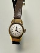 A vintage ladys Omega 18ct gold cased wristwatch with silvered dial and baton and arabic numerals on