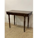 A Victorian mahogany tea table, the fold over revolving top raised on turned and tapered supports.