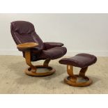 Ekornes, a Stressless maroon leather upholstered reclining and revolving chair with integrated table