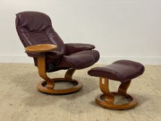 Ekornes, a Stressless maroon leather upholstered reclining and revolving chair with integrated table