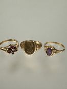 A 9ct gold horse shoe shaped signet ring M, a 9ct gold seven stone garnet cluster ring M and a 9ct
