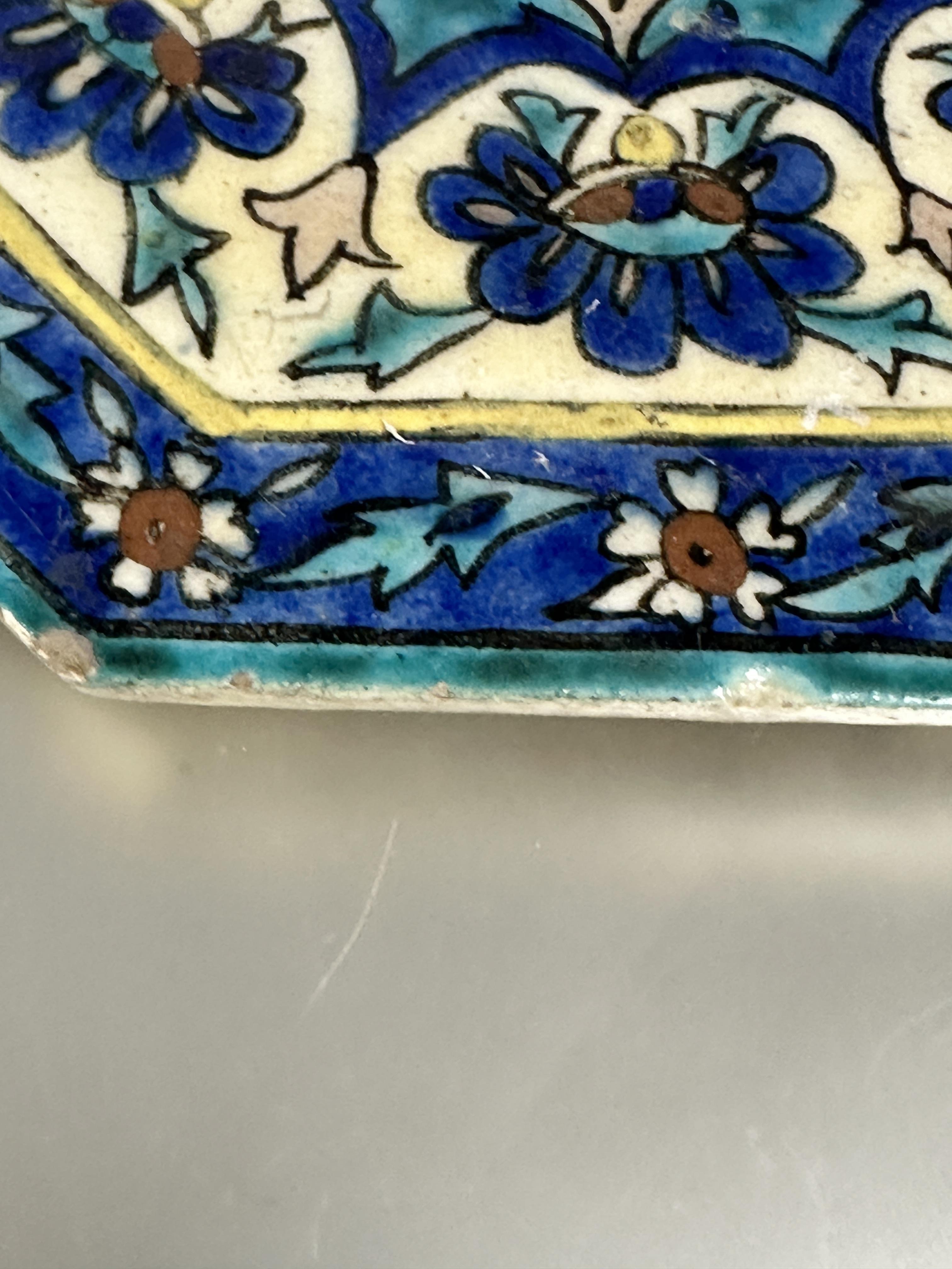 A Iznik glazed pottery octagonal tile with central flower enmclosed within a lotus leaf and flower - Image 6 of 7