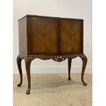 A mid 20th century burr walnut cocktail cabinet in the Georgian taste, plate glass top over two