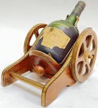 Courvoisier, a bottle of 'Napoleon' cognac brandy with cannon form bottle holder/pourer and label