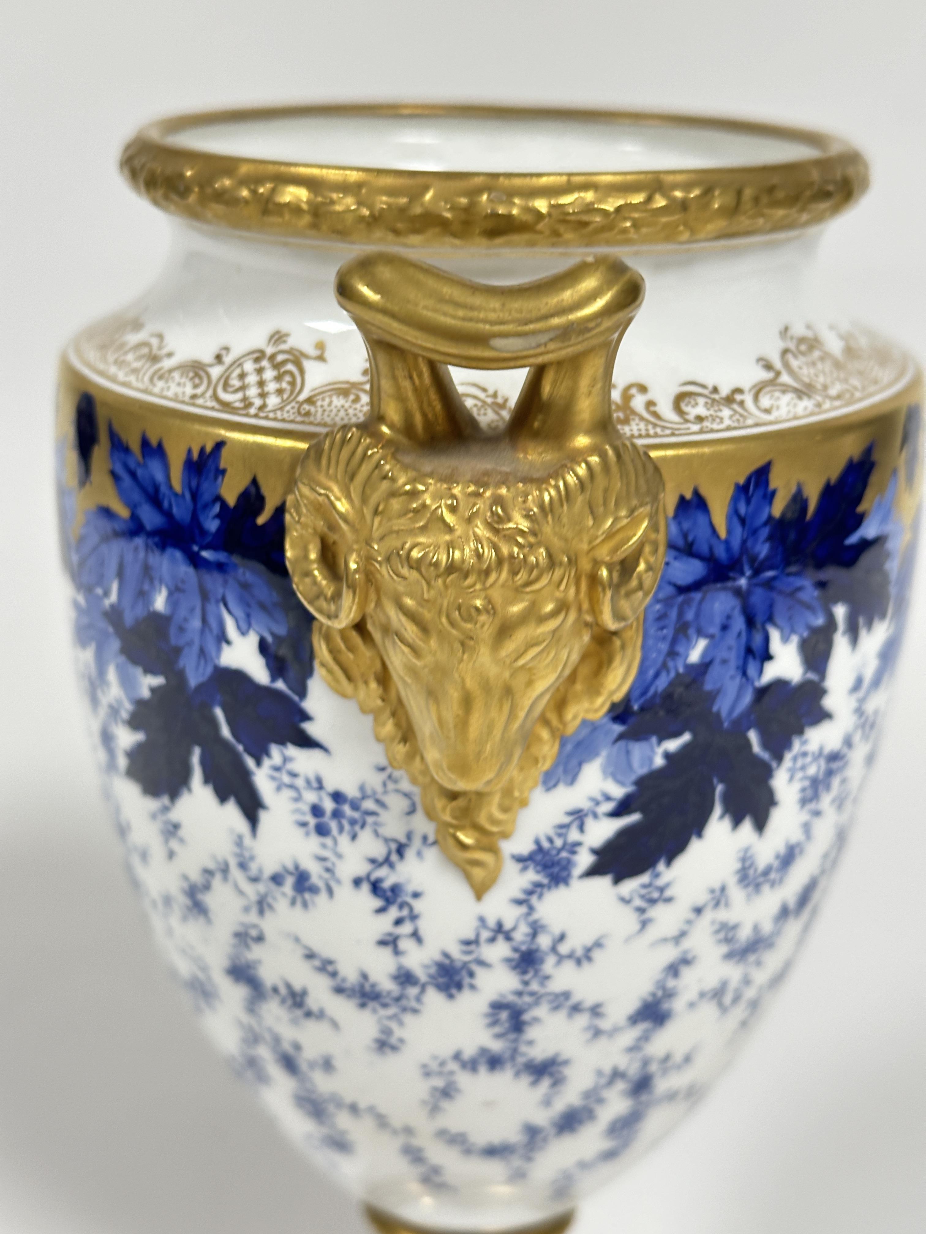 A early 20thc Coalport china two handled urn vase of tapered cylindrical form with twin gilt rams - Image 5 of 6