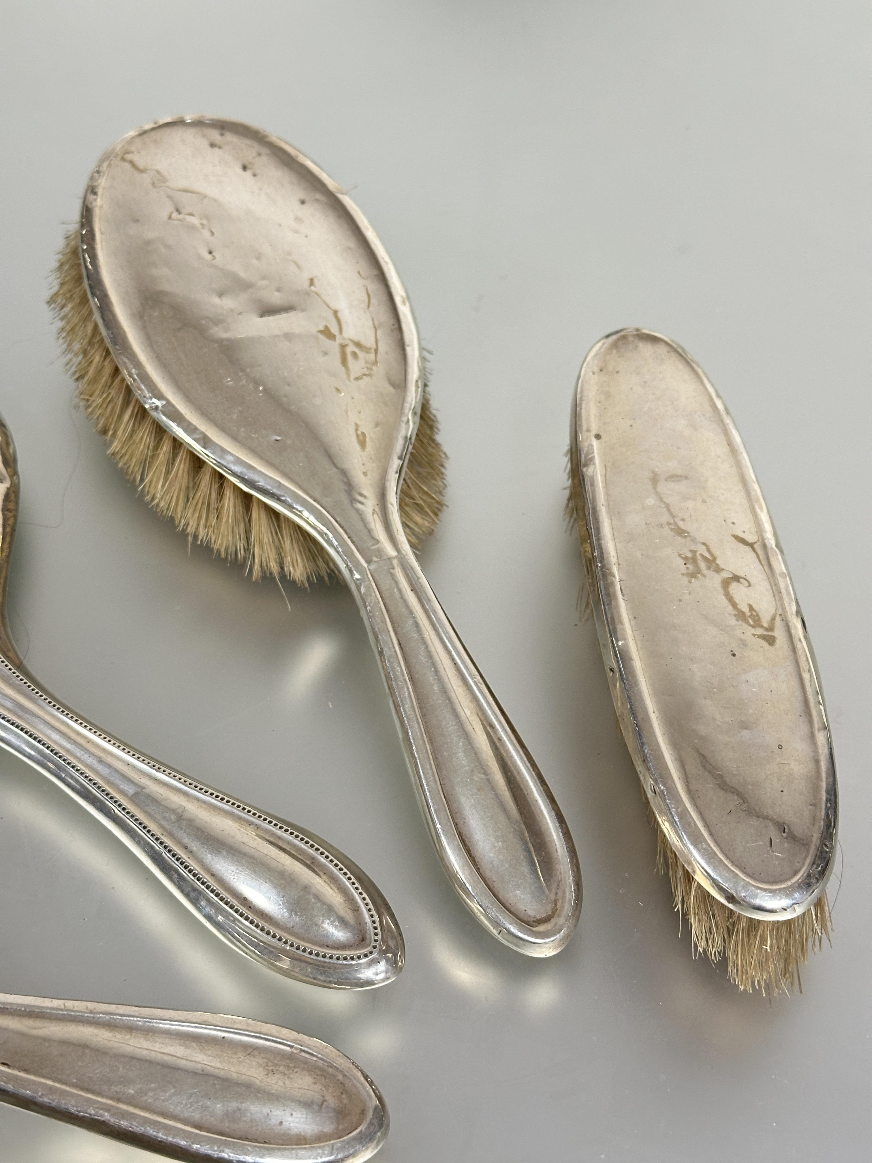 A Birmingham silver assembled dressing table set comprising a pair of oval hair brushes L x 24cm, - Image 4 of 4