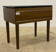 A mid century teak veneered sewing box stool, the vinyl covered top opening to a fitted interior
